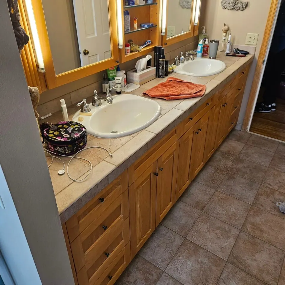 Bathroom before remodel with an oak vanity