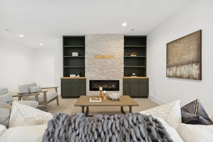 Family room fireplace with painted built-in shelves
