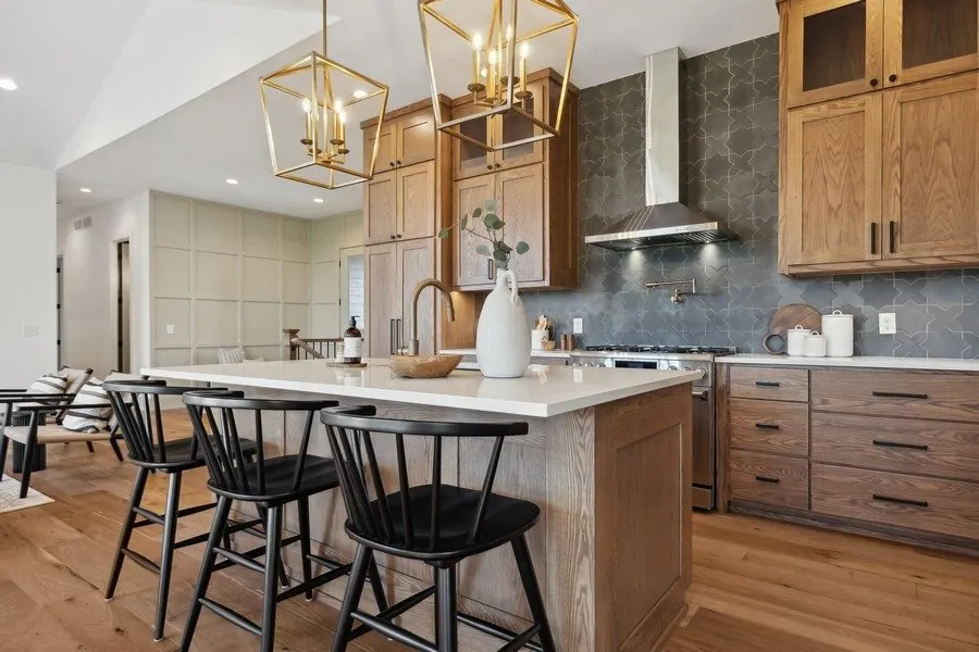 Kitchen range hood with stained cabinets and a white ceiling