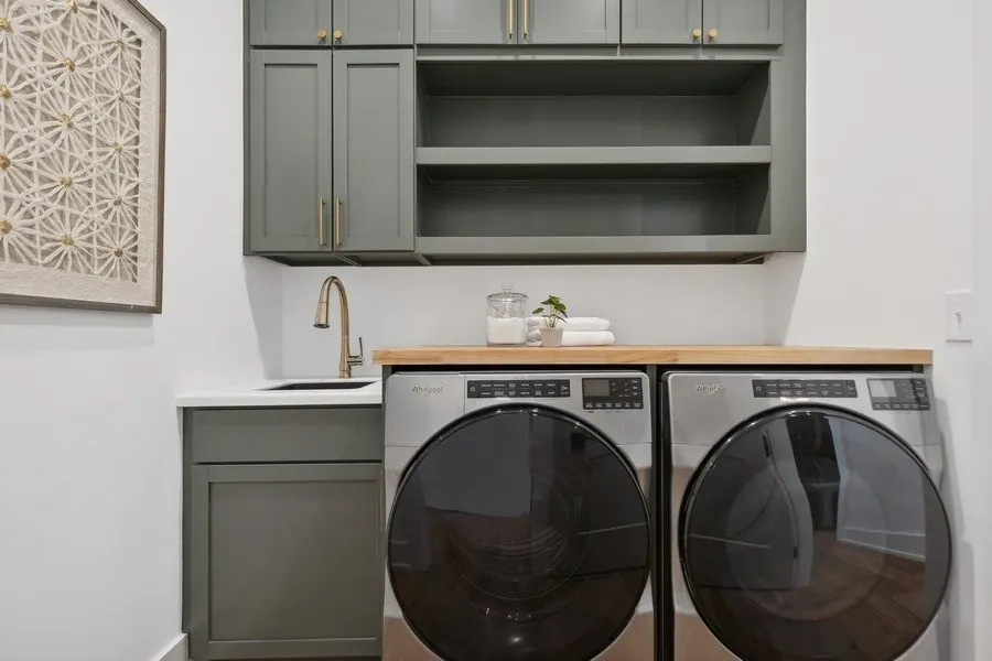 Laundry room with green enameled cabinets