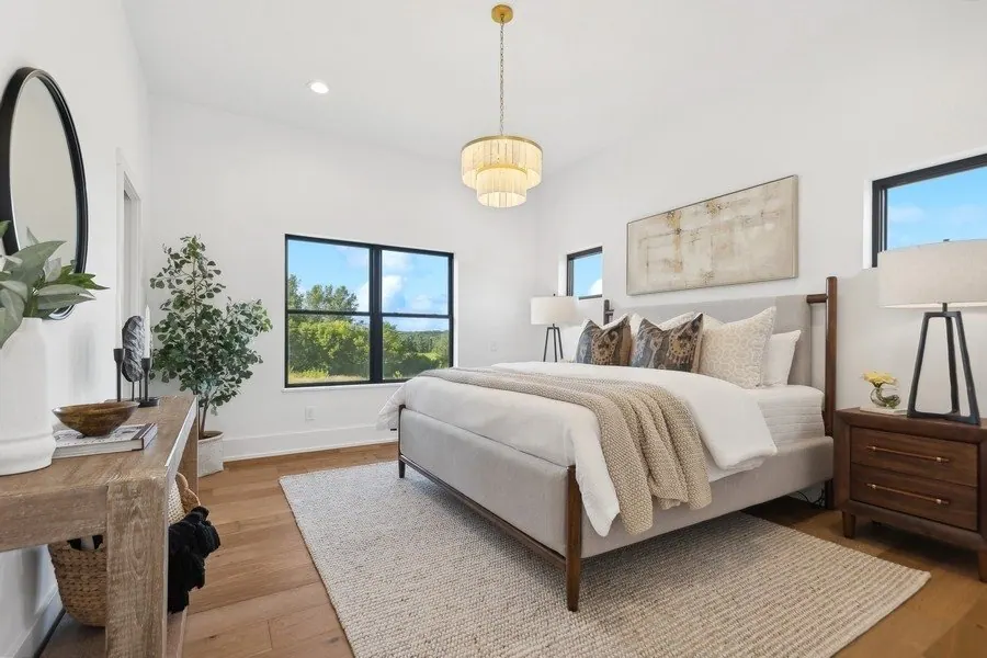 Bedroom with white walls and a wood floor